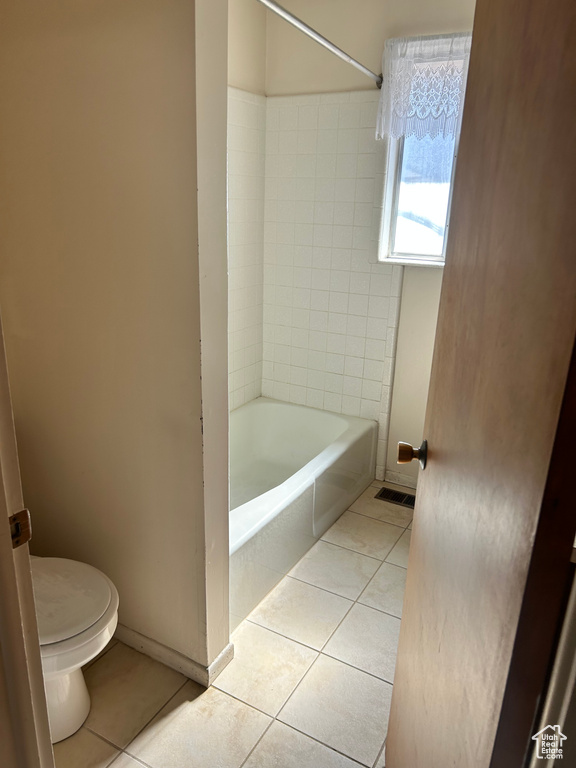 Bathroom with tile patterned flooring and tub / shower combination