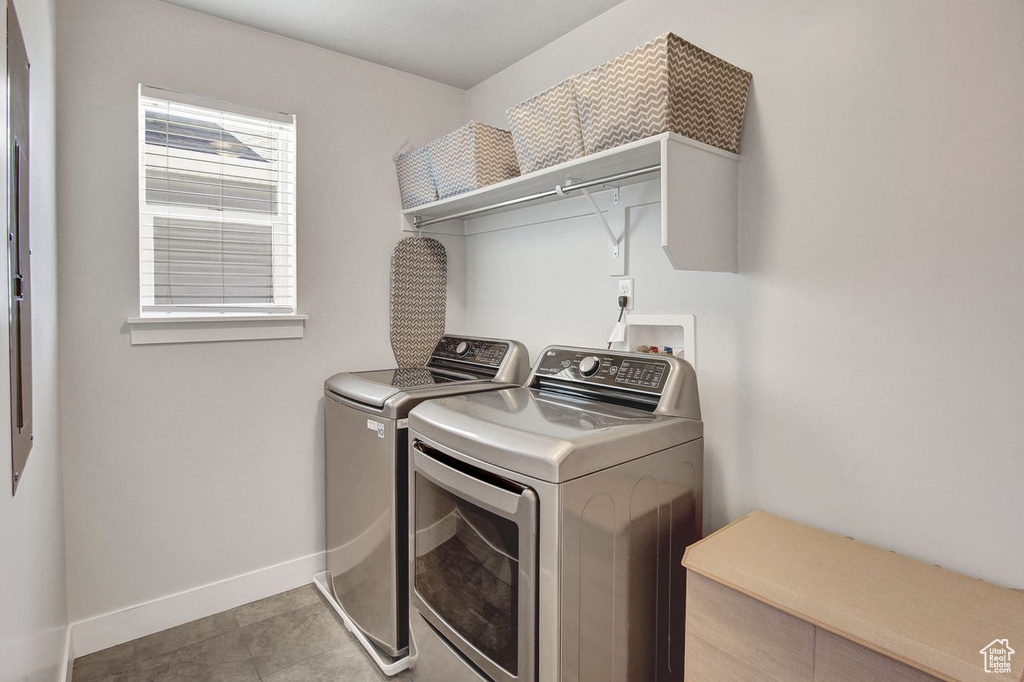 Washroom with washer and dryer and baseboards
