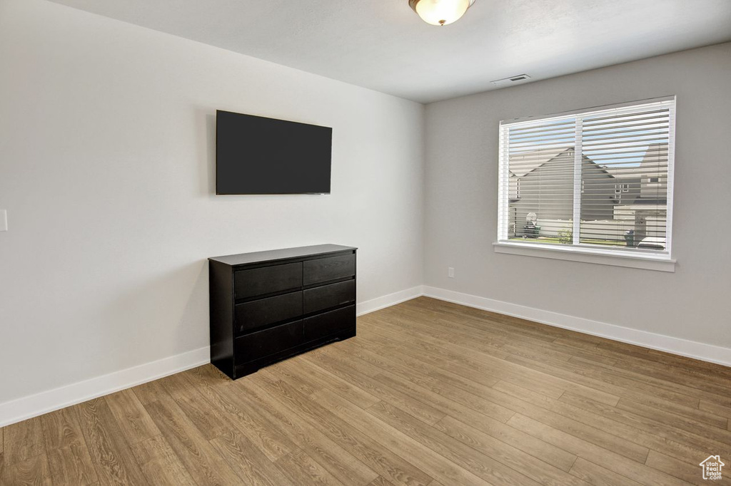 Unfurnished room featuring baseboards and wood finished floors