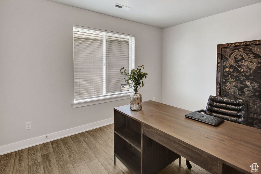 Home office featuring wood finished floors and baseboards