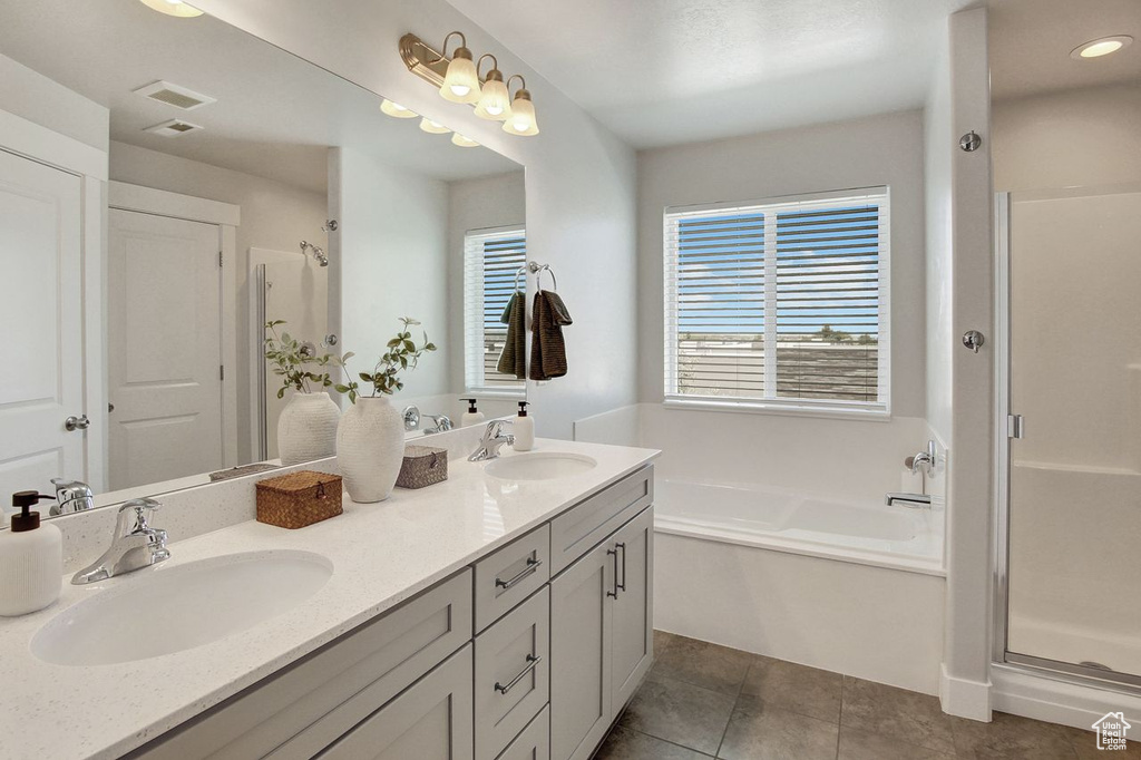 Bathroom with double vanity, a garden tub, a shower stall, tile patterned floors, and recessed lighting