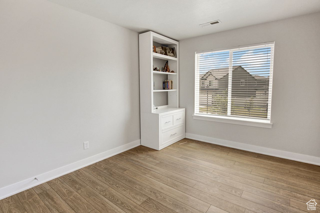 Spare room with light wood finished floors and baseboards
