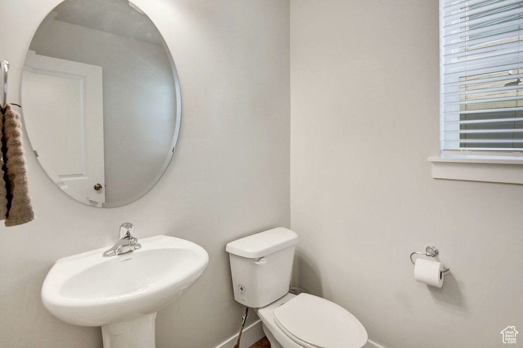 Bathroom featuring baseboards and toilet