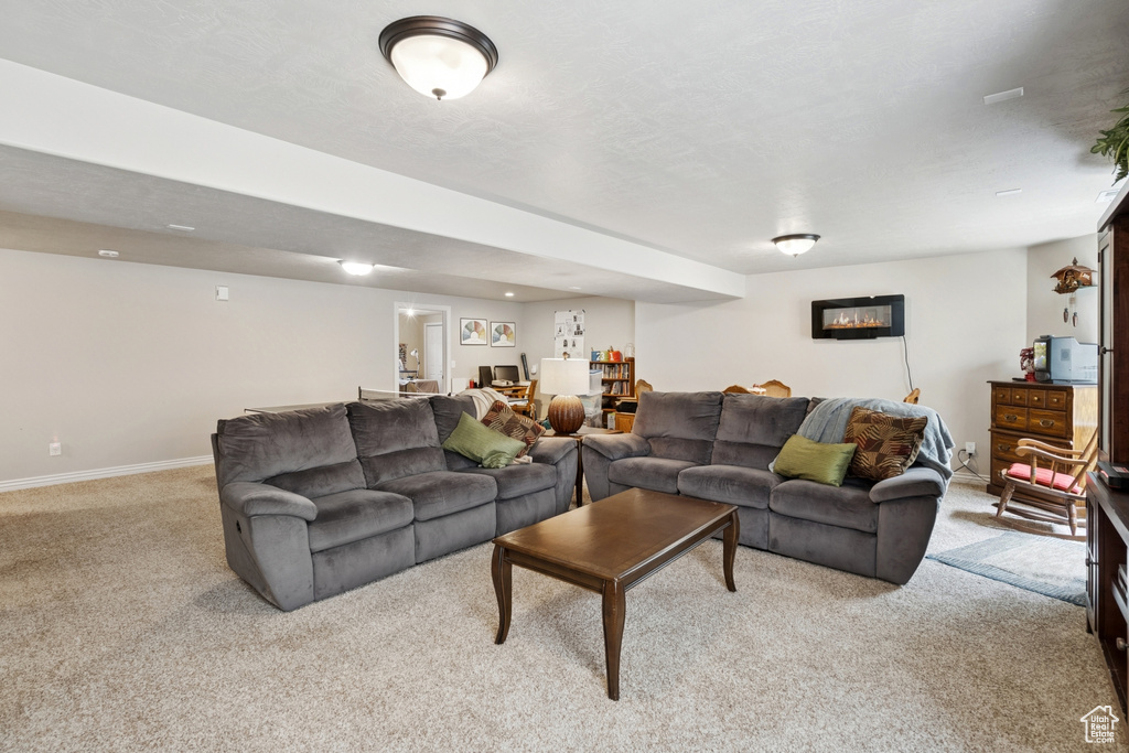 Carpeted living room with baseboards