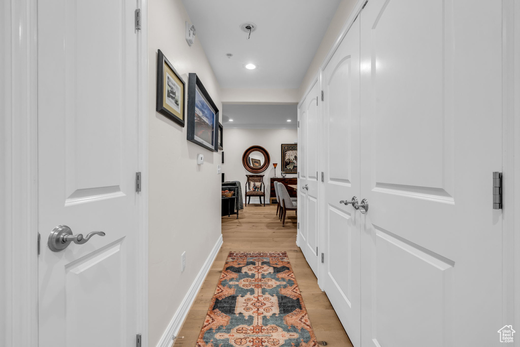 Hall with light wood-style flooring and recessed lighting