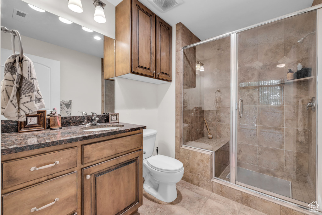 Full bathroom featuring vanity, a shower stall, and recessed lighting