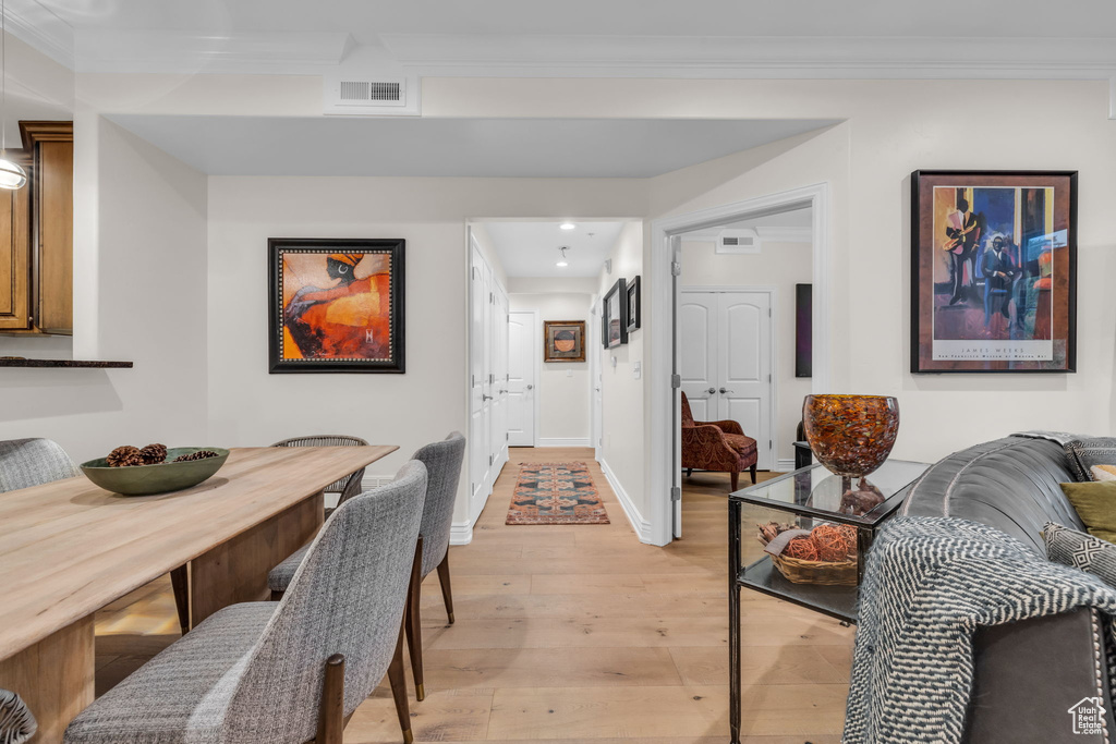Dining space featuring crown molding, light wood finished floors, and recessed lighting