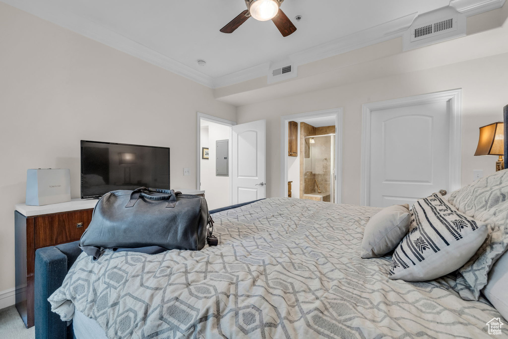 Bedroom with crown molding, electric panel, ensuite bathroom, and a ceiling fan