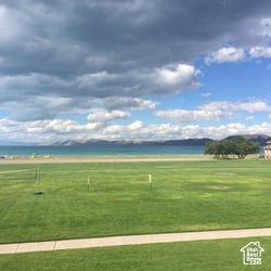 View of community featuring a water view and a yard