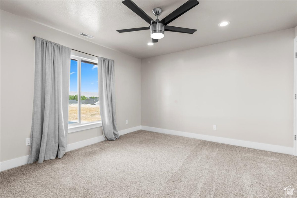 Spare room featuring carpet floors, ceiling fan, and recessed lighting