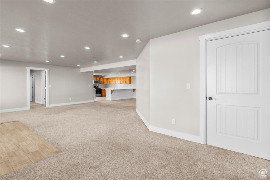 Unfurnished living room with recessed lighting and light colored carpet