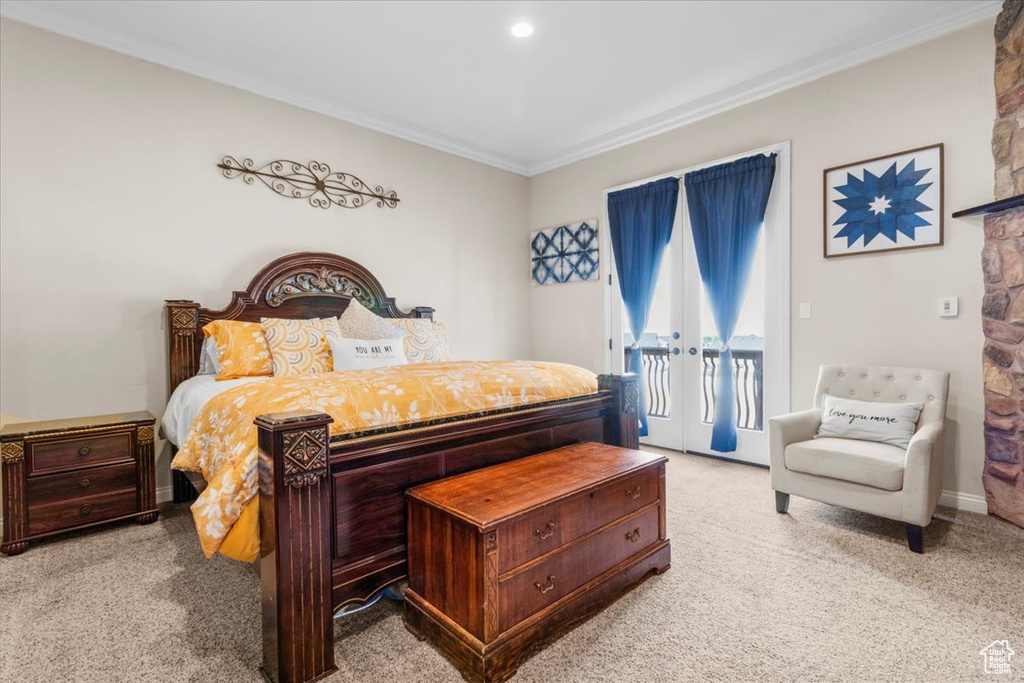 Bedroom featuring access to exterior, light colored carpet, and ornamental molding