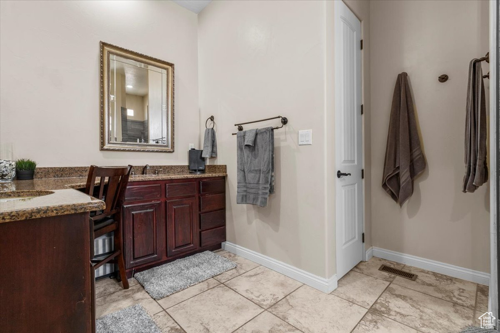 Bathroom with vanity and tile patterned flooring