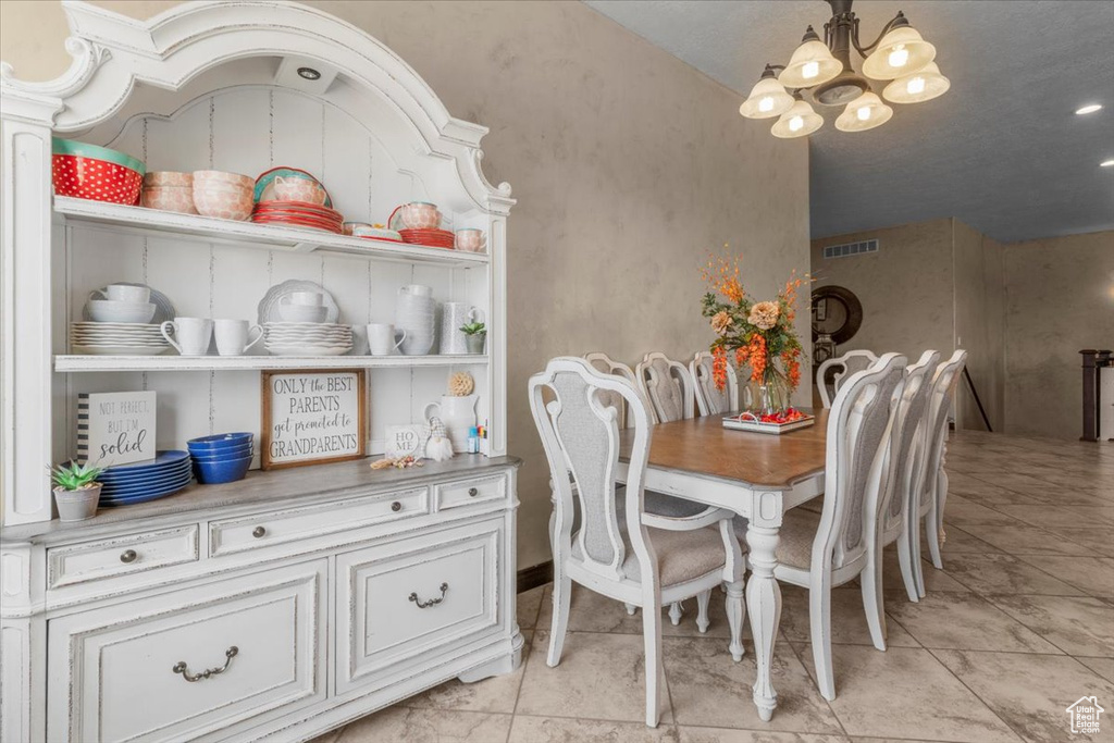Dining space with a chandelier and light tile patterned floors