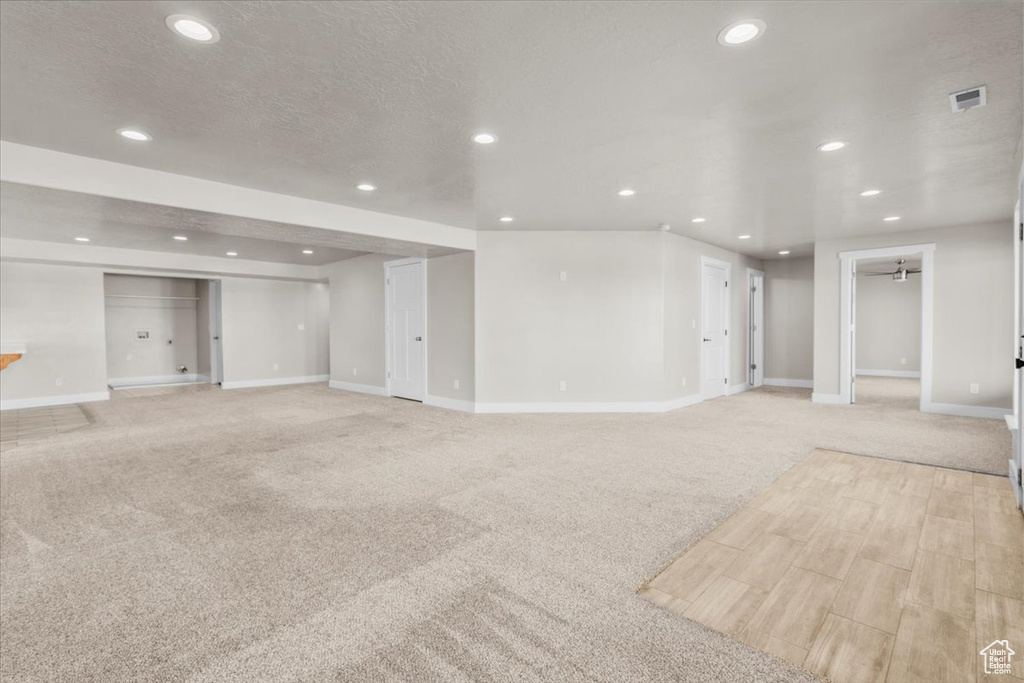 Unfurnished living room with recessed lighting and light colored carpet