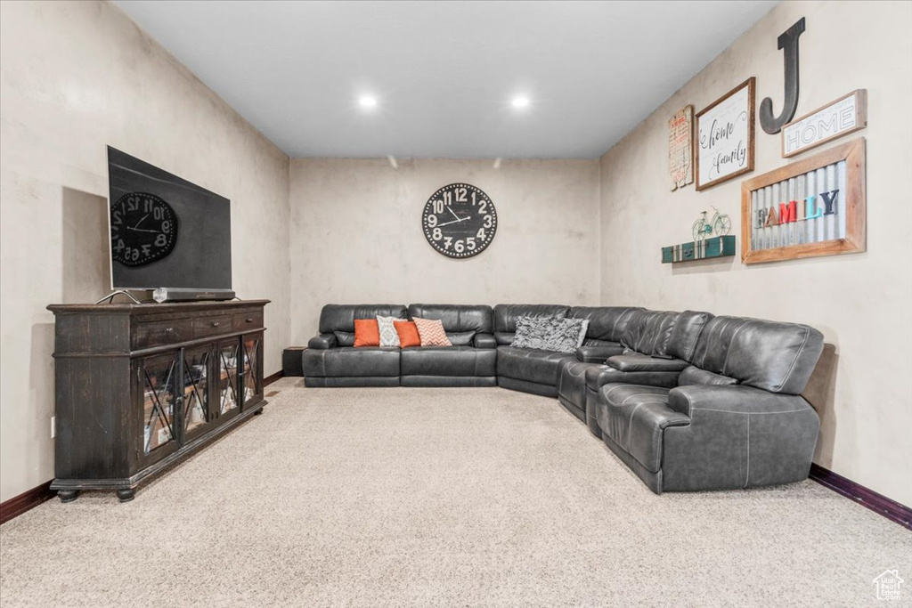 Carpeted living room with baseboards and recessed lighting