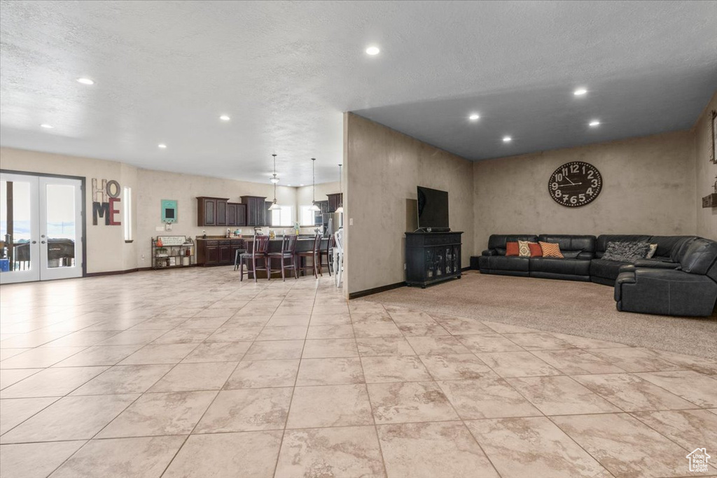 Living room with recessed lighting, french doors, and light tile patterned flooring