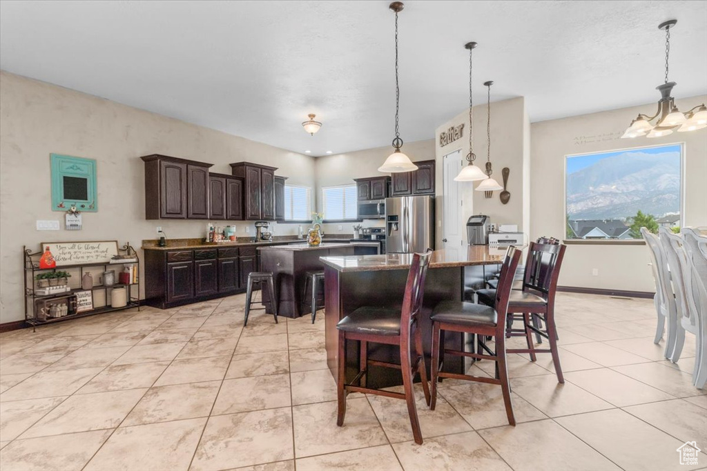 Dining area with a chandelier and light tile patterned flooring