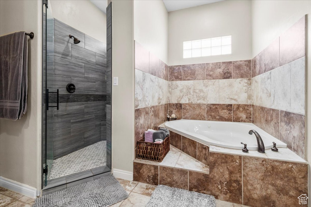 Full bathroom with a stall shower and a bath