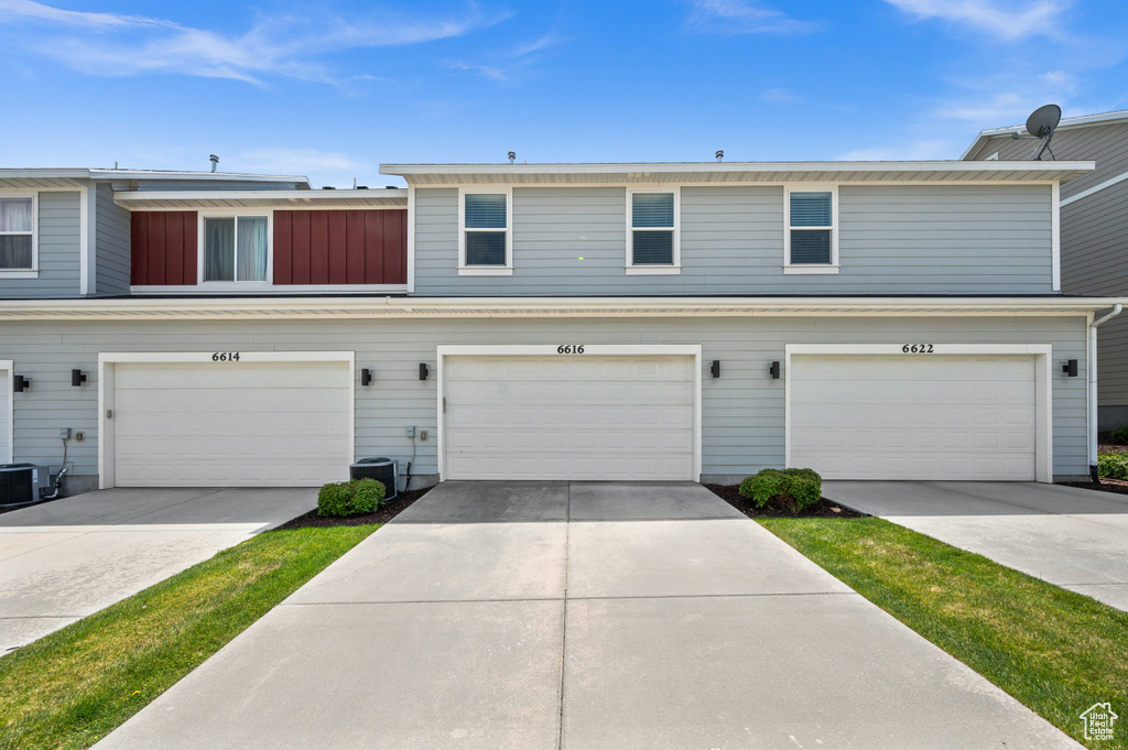 Traditional-style house featuring concrete driveway