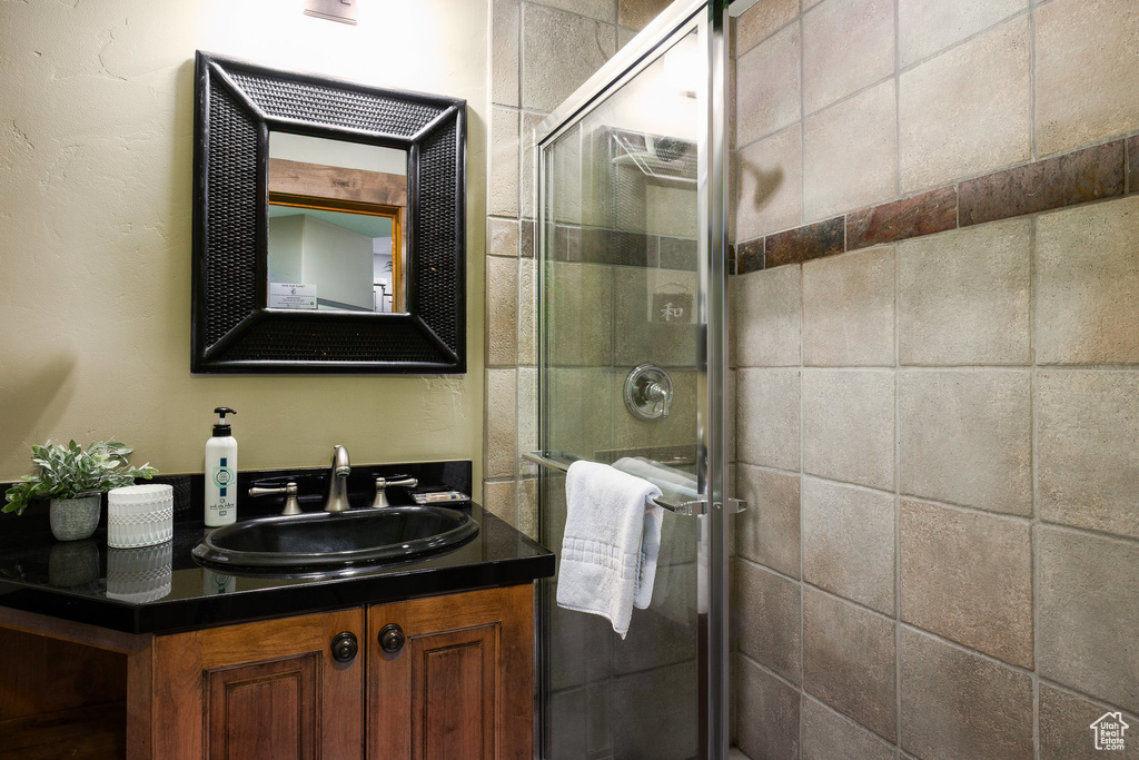 Bathroom with vanity and a shower stall
