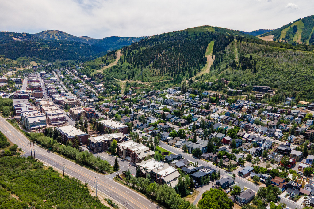 Aerial overview of property's location with a mountainous background and nearby suburban area