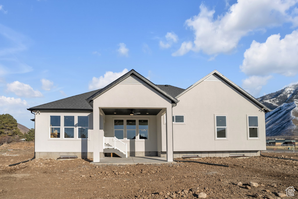 Back of house featuring a mountain view, a ceiling fan, and crawl space