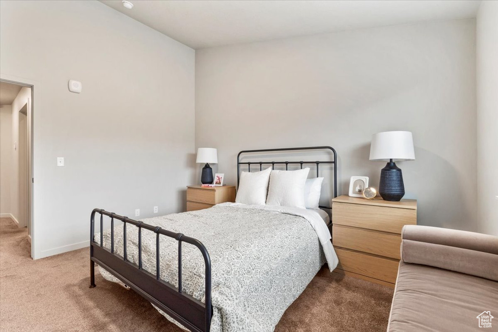 Carpeted bedroom featuring baseboards