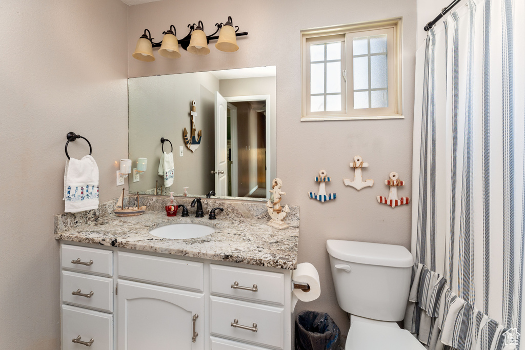 Full bathroom with vanity and toilet