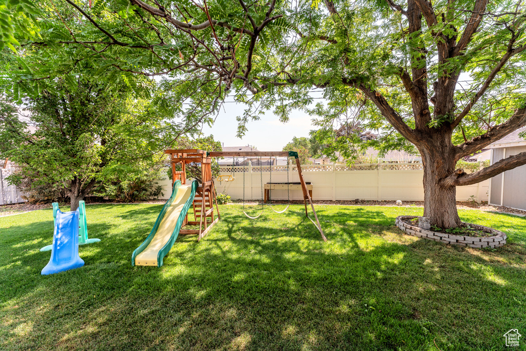 View of jungle gym featuring a fenced backyard