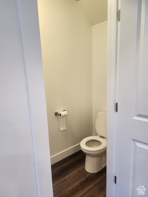 Bathroom with wood finished floors and a textured ceiling