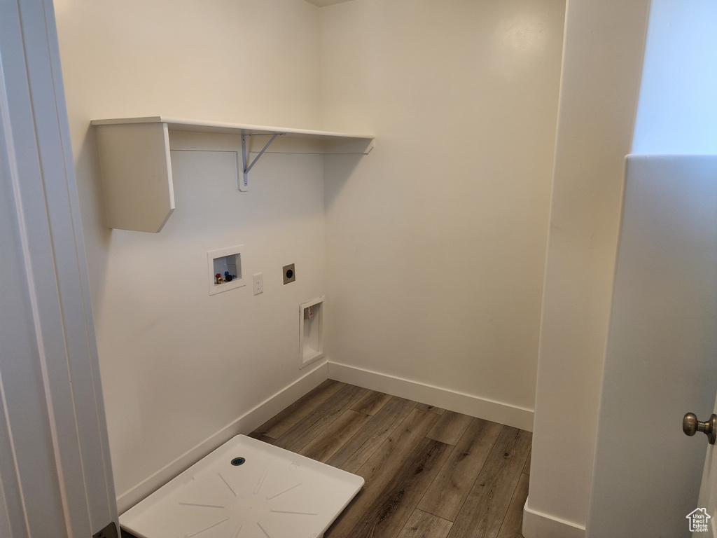 Laundry room with dark wood-style floors, hookup for a washing machine, and electric dryer hookup