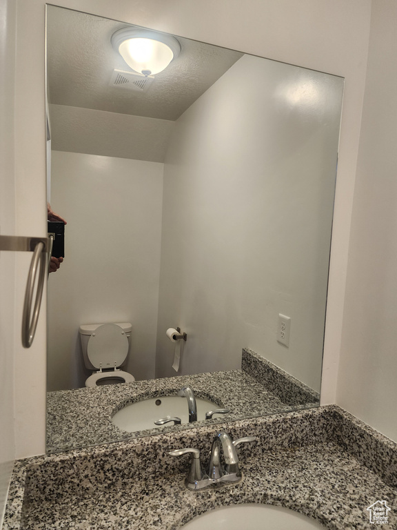 Bathroom featuring toilet and vanity