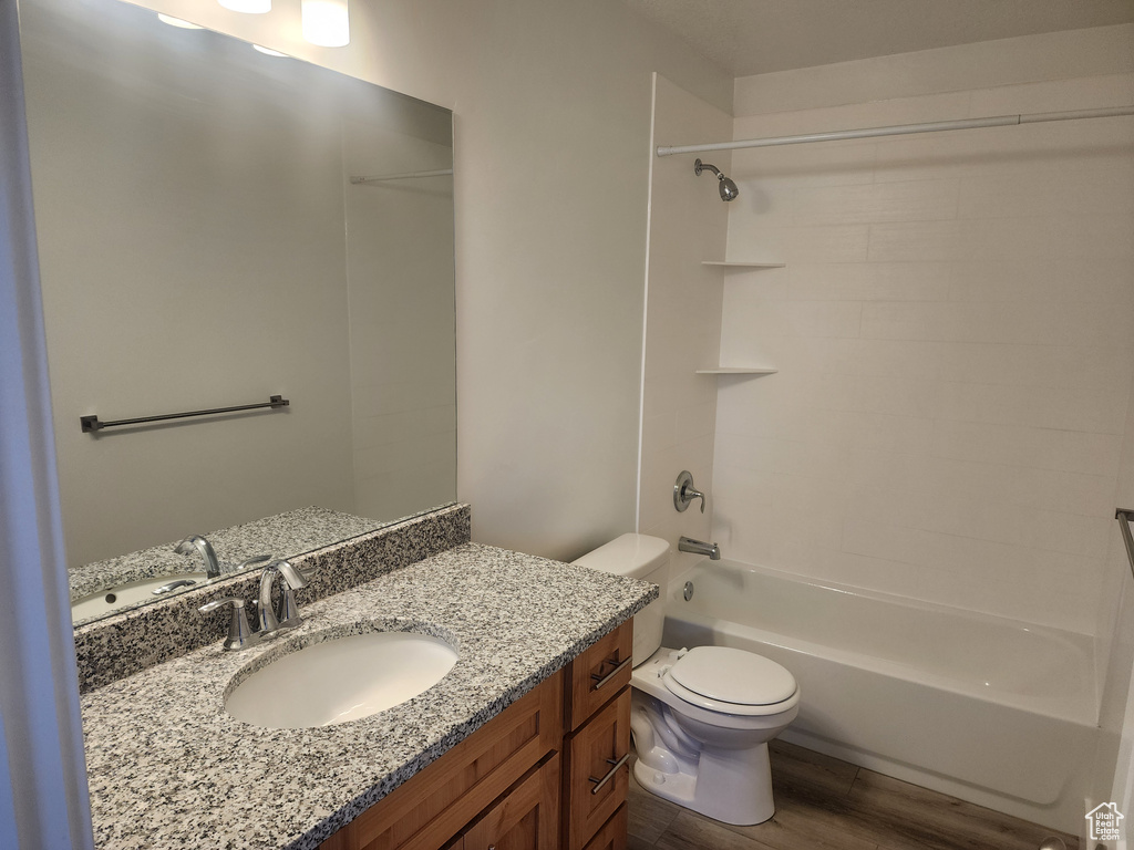 Full bathroom with vanity, wood finished floors, and shower / bath combination