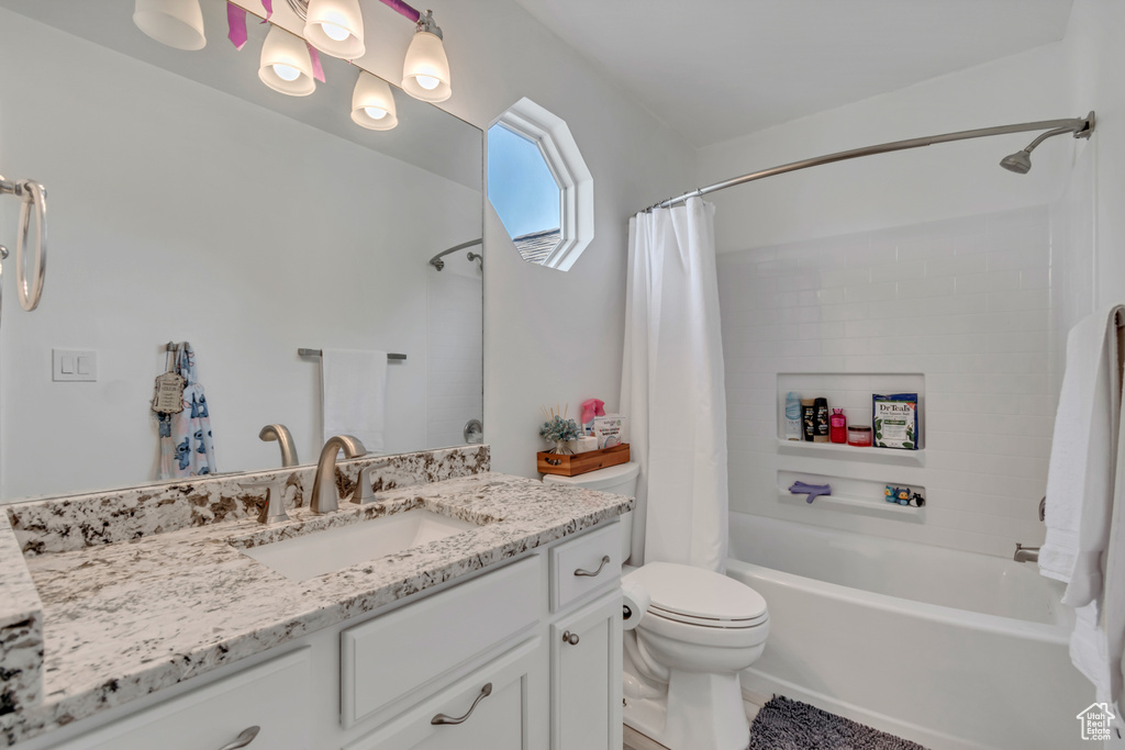 Full bath featuring vanity and shower / bathtub combination with curtain
