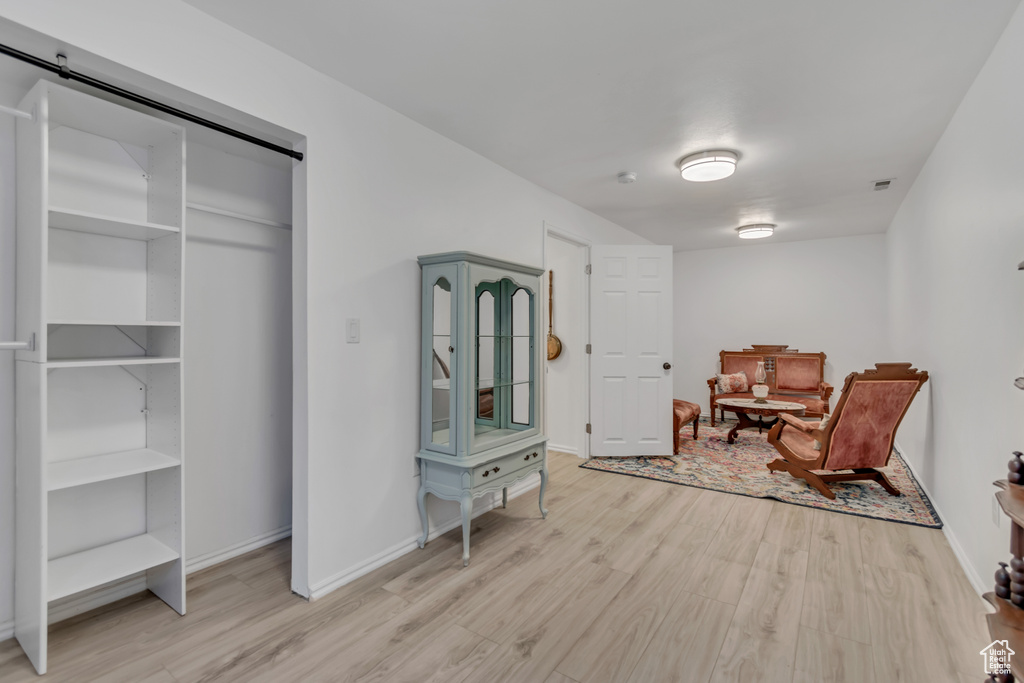 Living area with wood finished floors and a barn door