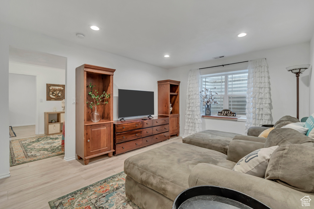 Living room featuring light wood-type flooring and recessed lighting