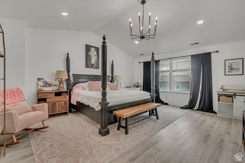 Bedroom featuring light wood finished floors, vaulted ceiling, a chandelier, and recessed lighting