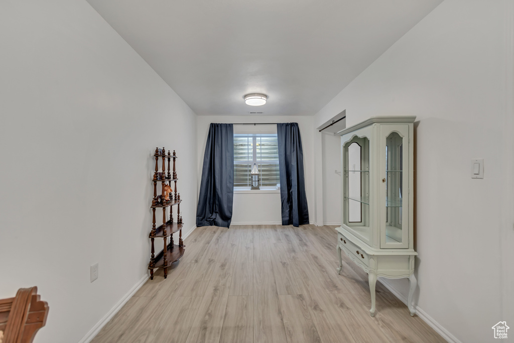 Empty room featuring light wood-type flooring and baseboards