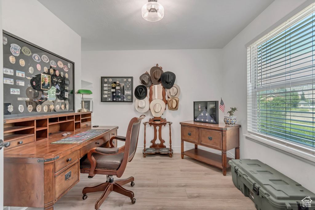 Office space featuring light wood-style flooring and baseboards