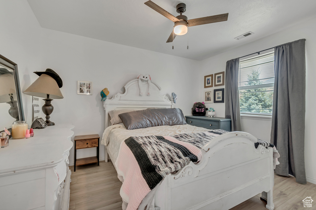 Bedroom featuring light wood-type flooring and a ceiling fan