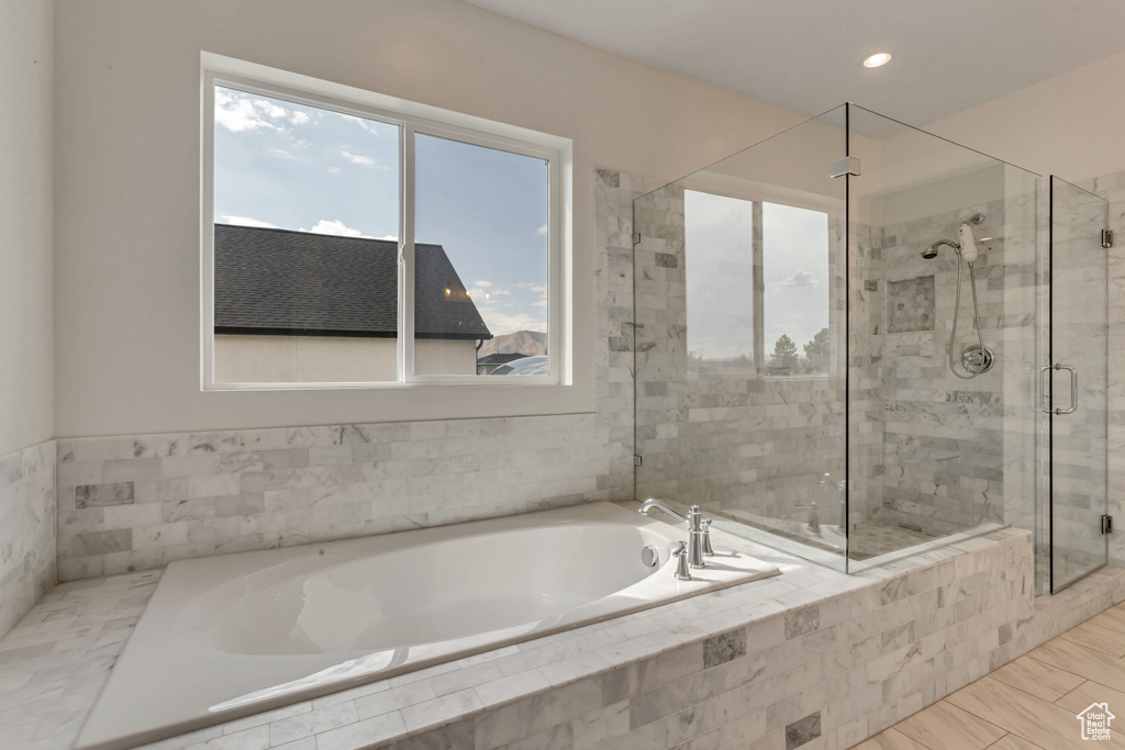 Full bath featuring a bath, a shower stall, and recessed lighting