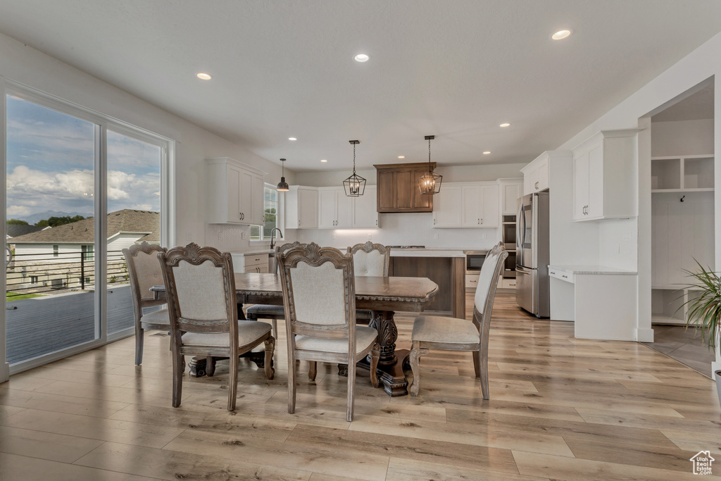 Dining space featuring recessed lighting and light wood finished floors