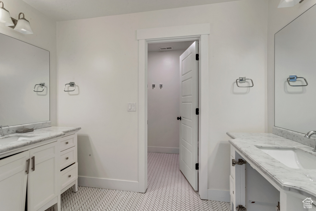 Bathroom featuring two vanities and tile patterned flooring