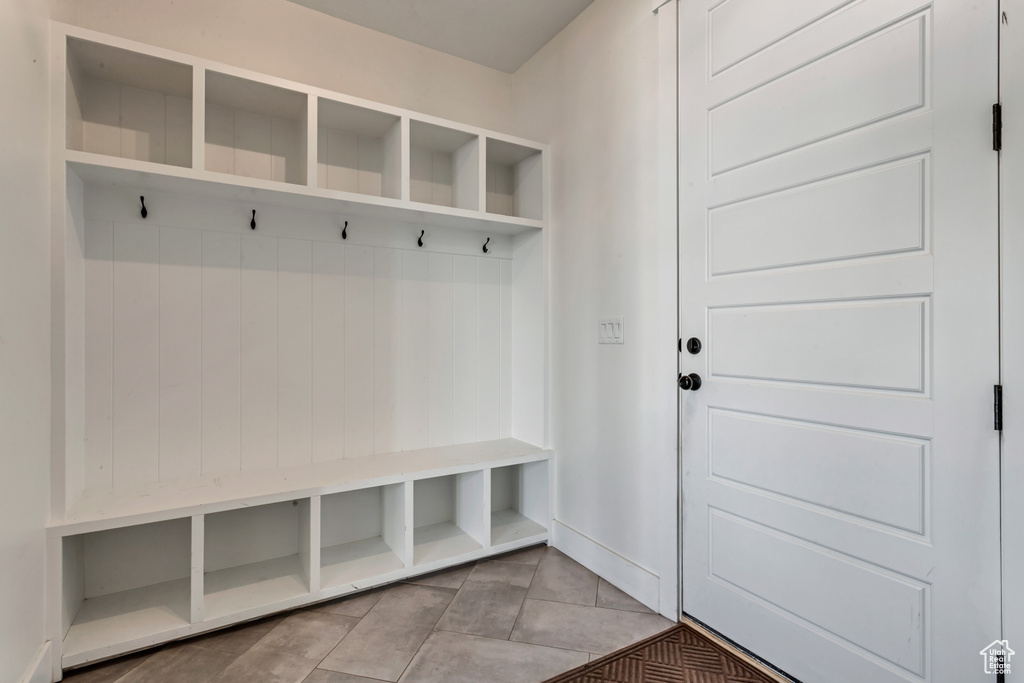 Mudroom featuring tile patterned floors and baseboards