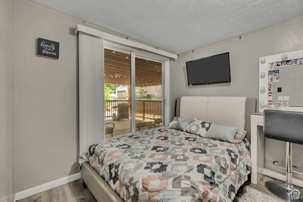 Bedroom featuring access to outside and wood finished floors