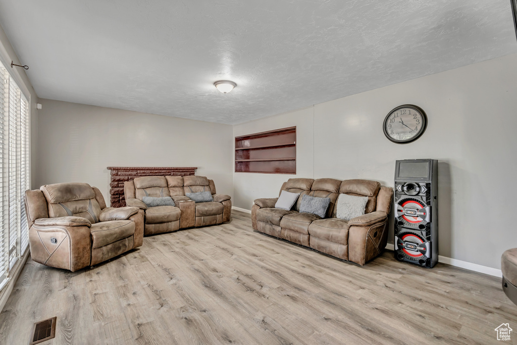 Living room with wood finished floors and a textured ceiling