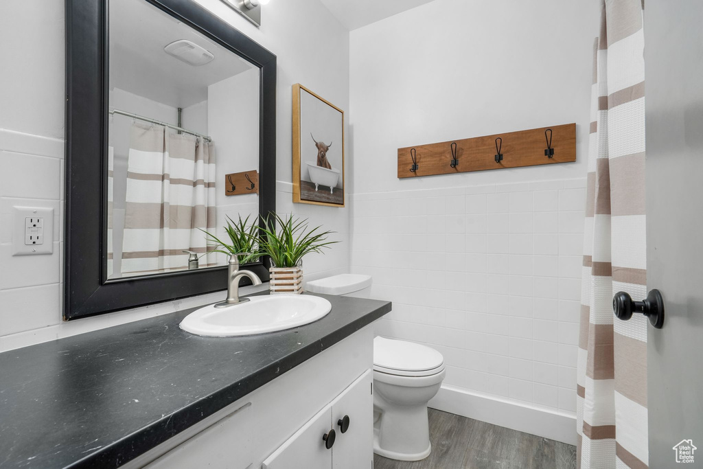 Full bath with vanity and wood finished floors