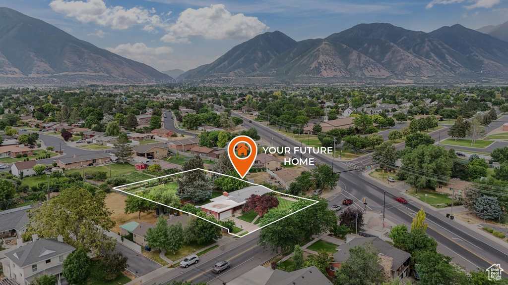 Aerial perspective of suburban area featuring property parcel outlined and a mountainous background