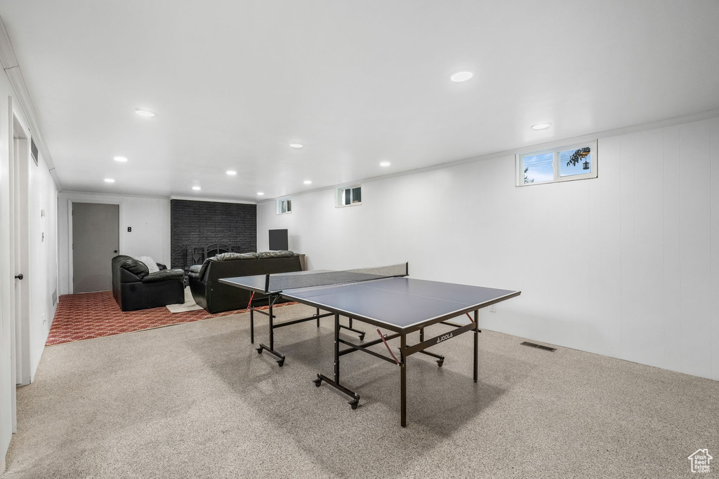 Game room featuring carpet floors, recessed lighting, and a fireplace